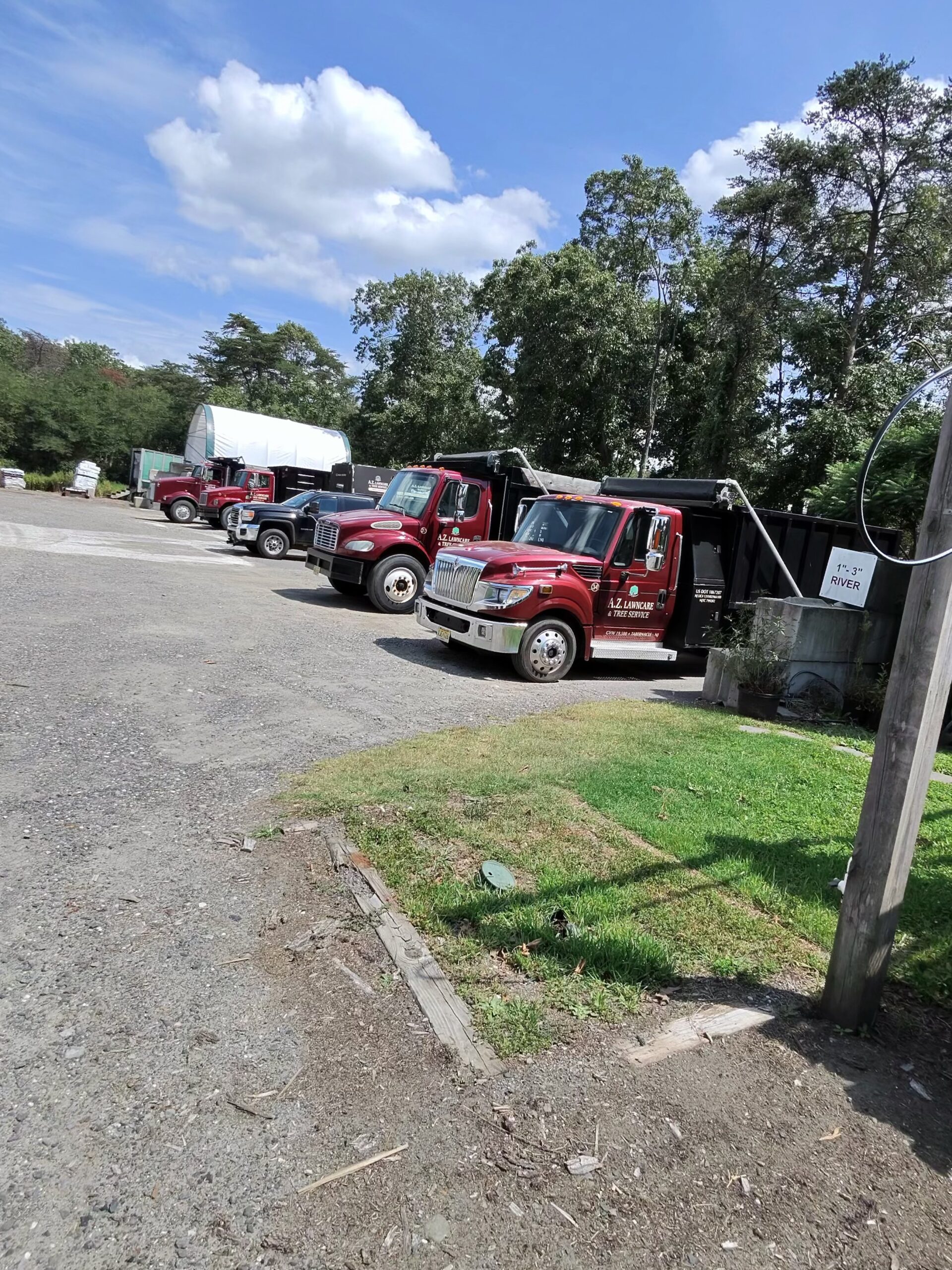 A.Z. work trucks lined up at the landscape yard