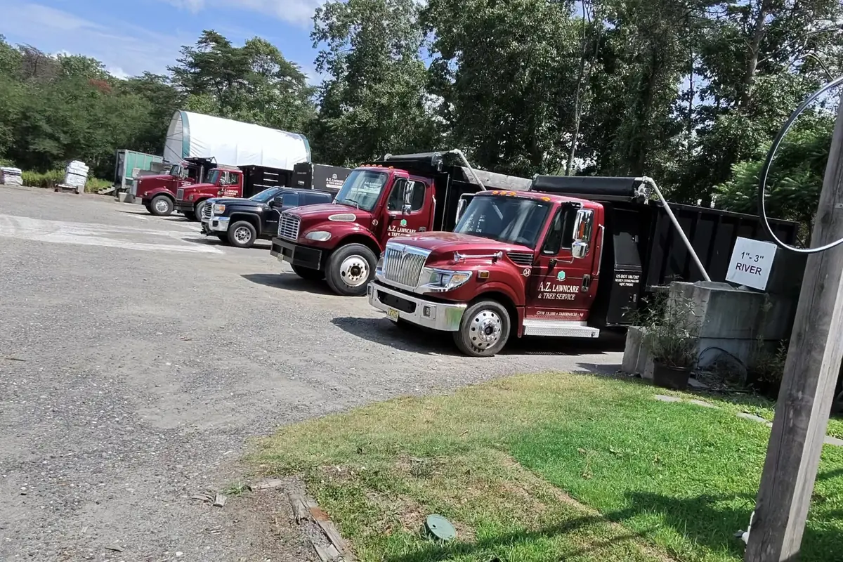 A.Z. work trucks lined up at the landscape supply yard in Tabernacle
