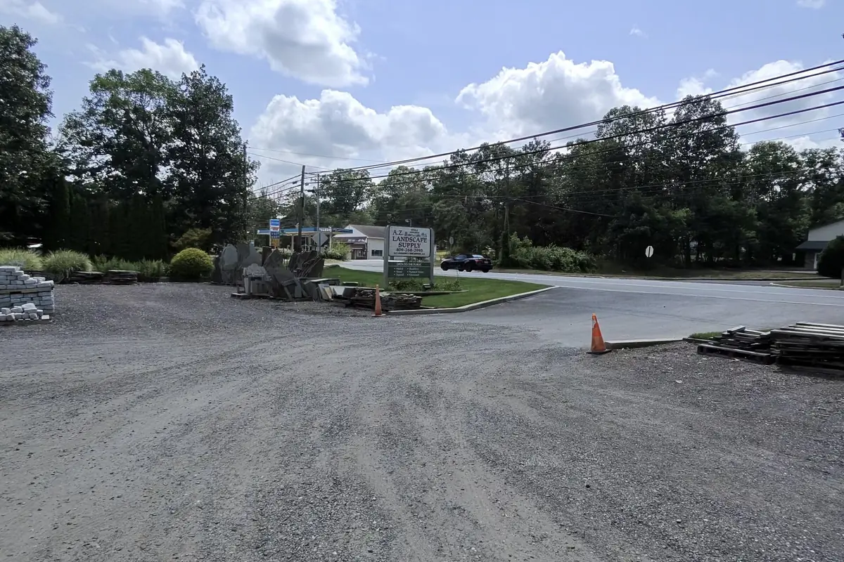 Bulk material bins and the yard entrance at A.Z. Landscape Supply on Route 206